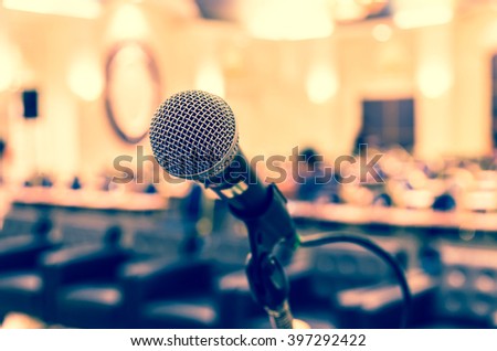 Microphone over the Abstract blurred photo of conference hall or seminar room background