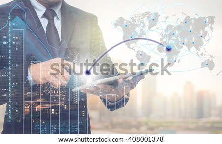 Double exposure of businessman using tablet for connection with cityscape and financial graph on blurred building background,Business Trading concept,Elements of this image furnished by NASA
