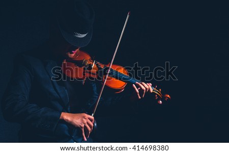 Violin player in dark studio, Musical concept