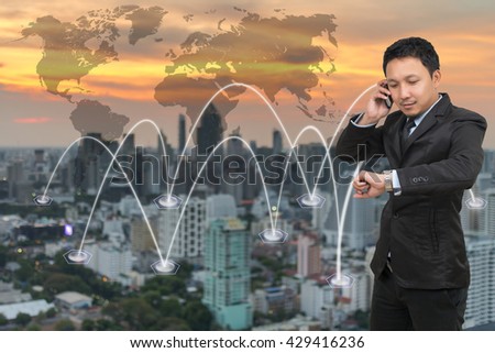 Asian businessman calling mobile phone with network connection on cityscape with world map background, Business connection concept, Elements of this image furnished by NASA,
