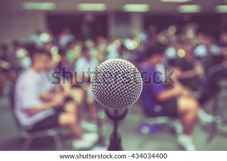 Microphone over the Abstract blurred photo of classic music band when rehearsal, musical concep, seminar meeting concept