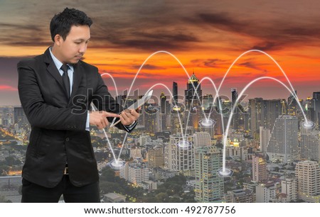 Asian businessman calling mobile phone with network connection on cityscape background, Business connection concept