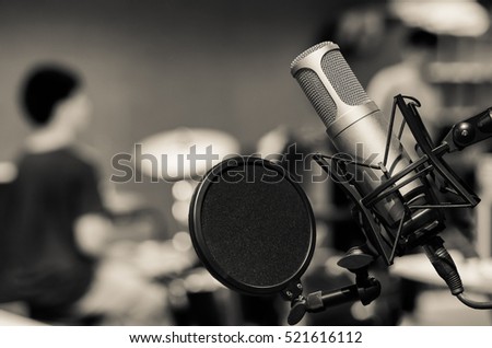 Professional condenser studio microphone over the musician blurred background, Musical instrument Concept