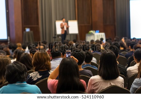 Speakers on the stage with Rear view of Audience in the conference hall or seminar meeting, business and education concept