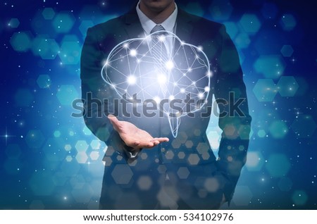 Businessman hand holding the brain over the Abstract Hexagon bokeh background on blue color background, technology and innovation concept