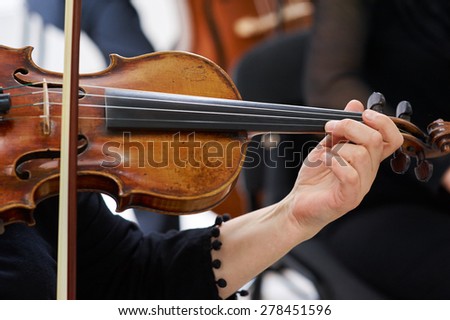Women Violinist Playing Classical Violin Music in Musical Performance