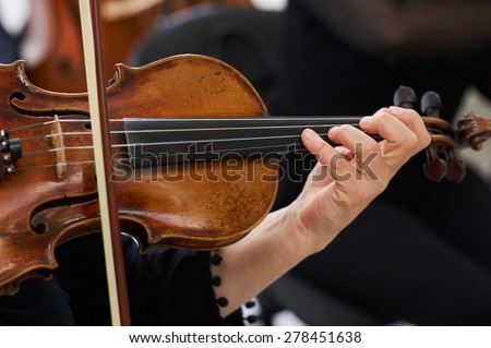 Women Violinist Playing Classical Violin Music in Musical Performance