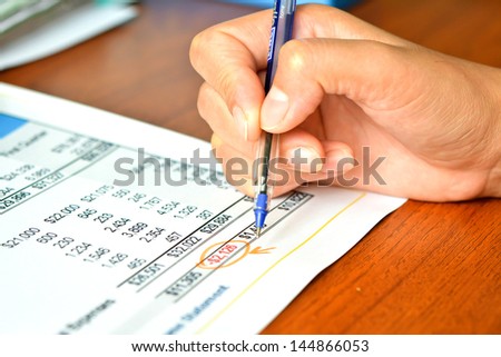 Finance budget report with hand of someone
