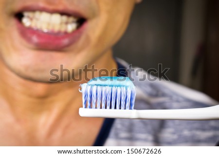 Toothbrush with tooth paste on a mouth of someone background