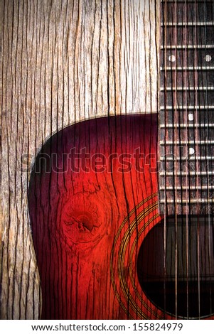 acoustic guitar art on wooden wall