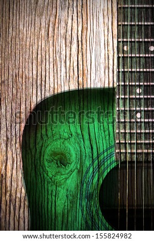 acoustic guitar art on wooden wall