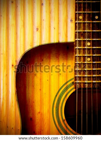acoustic guitar art on wooden wall background