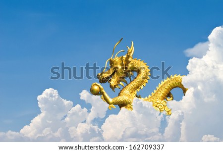Golden Chinese Dragon flying on the sky with cloudy