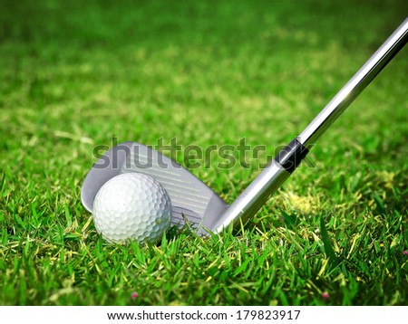 Golf ball with golf club on green glass