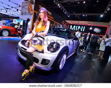 BANGKOK - April 4 : Unidentified model with Mini Cooper on display at The 35th Bangkok International Motor Show on April 4, 2014 in Bangkok, Thailand