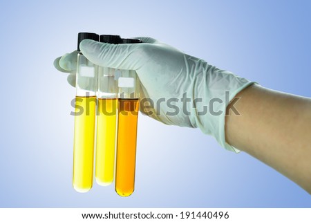 glass tube tube with fluid in scientist hand