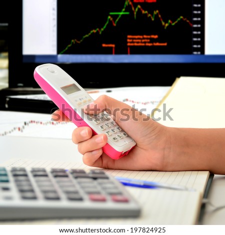 Telephone in woman hand at office