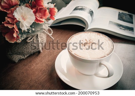 Cappuccino coffee with flowers bouquet