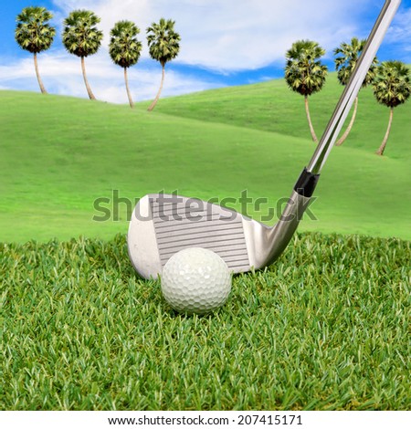 Golf ball and golf club with hill background