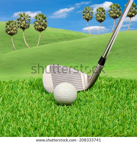 Golf ball and golf club with hill background