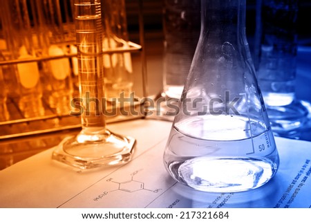 Laboratory glassware with science document