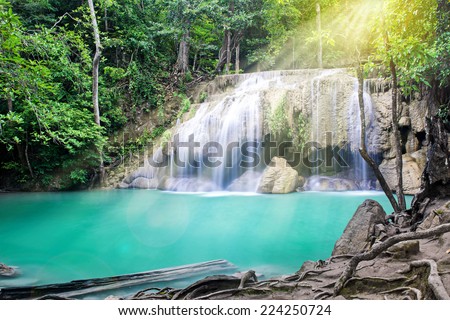 Erawan waterfall with sunshine in tropical forest, Thailand