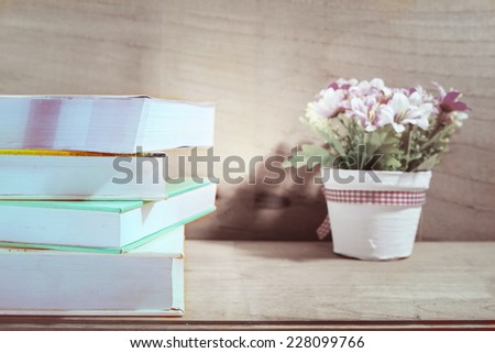 Text books on wooden desk, vintage tone
