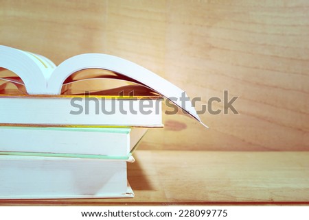 Text books on wooden desk, vintage tone