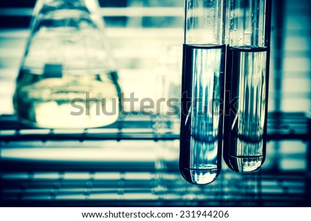 Laboratory research, test tubes containing chemical liquid with lab background