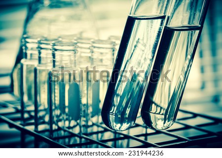 Laboratory research, test tubes containing chemical liquid with lab background