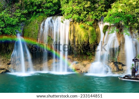 Beautiful waterfall with rainbow in tropical forest, Thailand