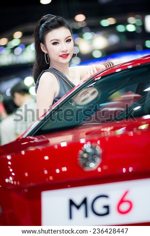 BANGKOK - NOVEMBER 30 : Unidentified model with MG on display at The 31st Bangkok International Motor Expo on November 30, 2014 in Bangkok, Thailand.