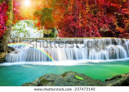Huay Mae Khamin waterfall with rainbow in deep forest of national park, Thailand