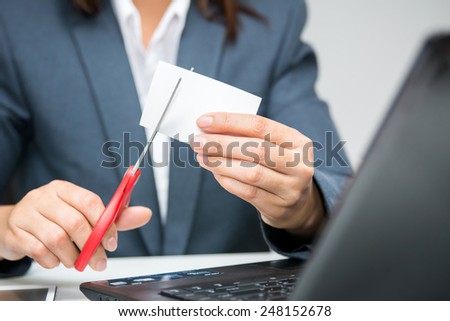 Business woman cutting unusable name card