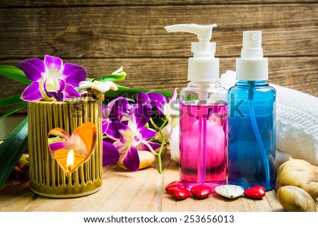 Essential body massage oils in a bottles with violet orchid for body treatment