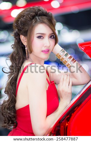 BANGKOK - DECEMBER 6, 2014 : Unidentified model with MG on display at The 31st Bangkok International Motor Expo on DECEMBER 6, 2014 in Bangkok, Thailand.