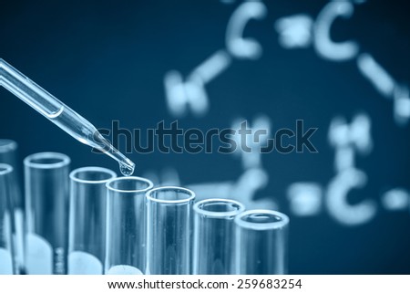 Laboratory research, dropping liquid to test tubes, Blue tone