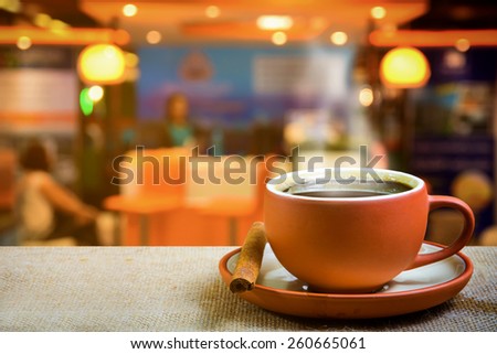 Cup of espresso with coffee shop background