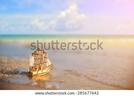 Sailing ship model on the beach, discovery concept