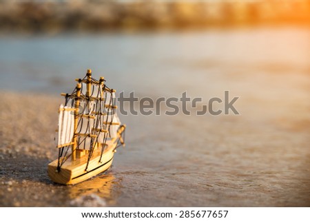 Sailing ship model on the beach, discovery concept
