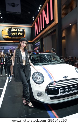 BANGKOK - April 5, 2015 : Unidentified model with Mini car on display at The 36th Bangkok International Motor show on April 5, 2015 in Bangkok, Thailand.