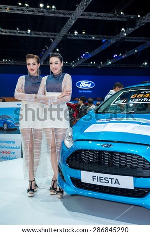 BANGKOK - April 5, 2015 : Unidentified model with Ford car on display at The 36th Bangkok International Motor show on April 5, 2015 in Bangkok, Thailand.