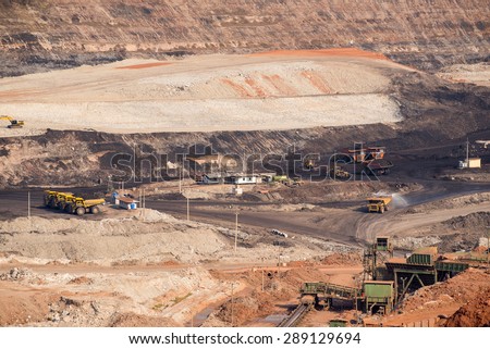 Part of a coal mine pit with big mining truck working