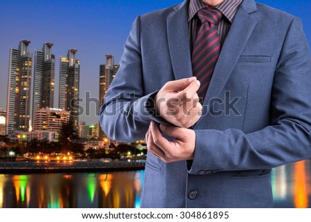 Business man in suit on blur city night background
