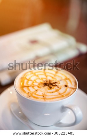 Cappuccino coffee on the table, vintage warm tone