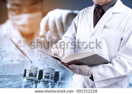Doctor reading text book with blur scientist in laboratory background