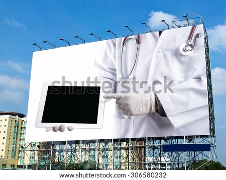 doctor holding touch pad on billboard