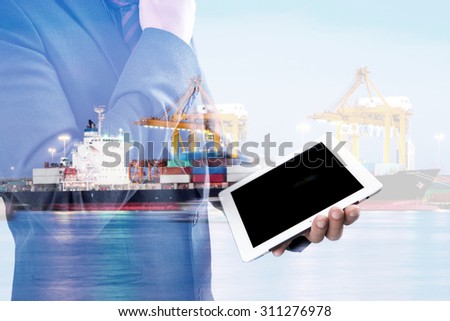 double exposure of businessmen using tablet at meeting with blur ship at port at night