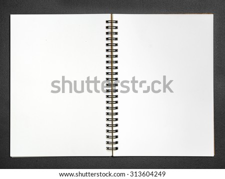 Blank open notebook on black background