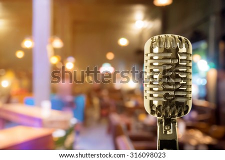 Retro microphone against blur colorful light restaurant background